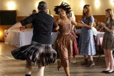 Iona (Ruth Negga) dancing at the ceildh
